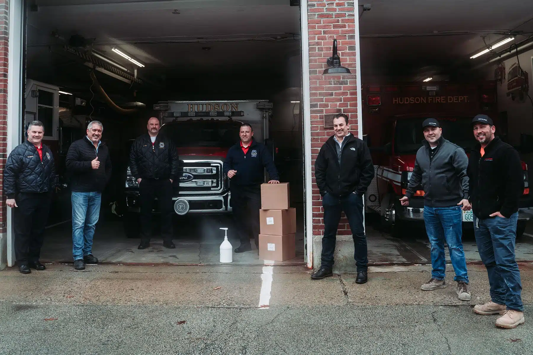 The Optiline team standing in front of their local fire department
